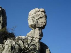 Скала, напоминающая человеческую голову, на фоне неба